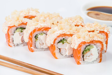 Appetizing maki sushi rolls with rice, salmon, tuna and sauce on light background
