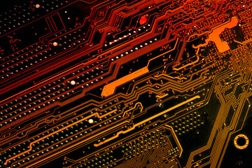 Close up of a printed diagonal red and yellow computer circuit board