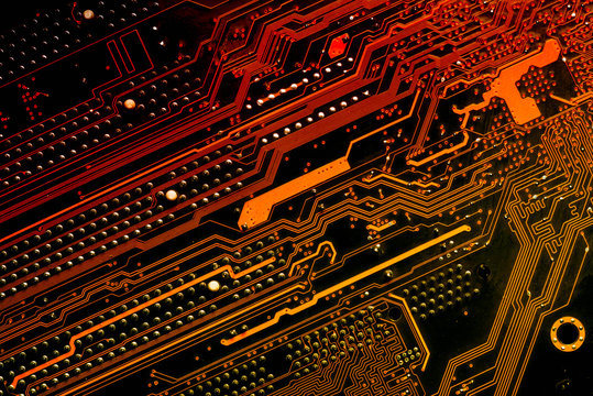 Close up of a printed diagonal red and yellow computer circuit board