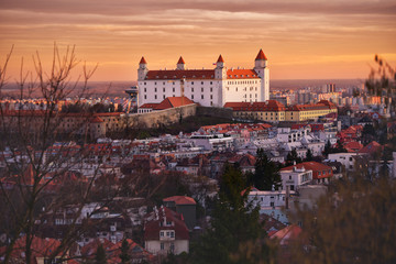 Fototapeta na wymiar Bratislava castle in orange sunset light. Old historical town Slovakia