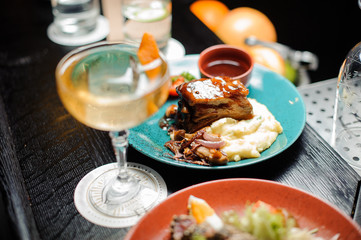 Alcoholic cocktail arranged on the table with a tasty meat dish