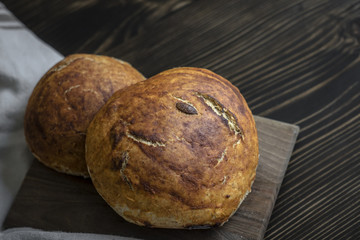 Freshly baked bread on dark  kitchen table
