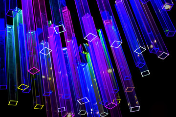 Abstract black background with light colored neon prisms