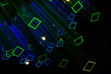 Abstract black background with light colored neon prisms