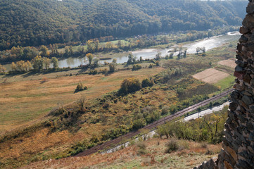 Naklejka premium view of a river and forest on a sunny autumn day