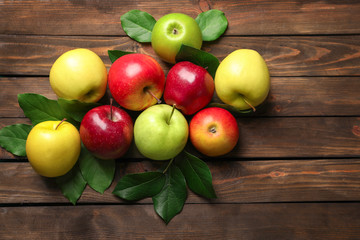 Ripe juicy apples on wooden table, top view