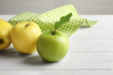 Ripe juicy apples on wooden table