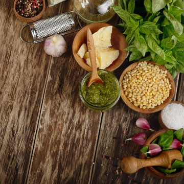 Top view of Pesto sauce ingredients and utensils on wood table
