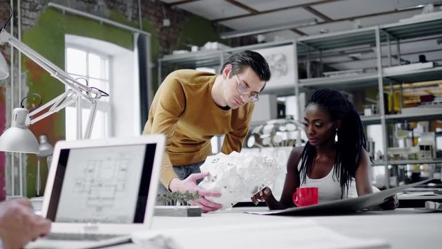 Multiracial team working in design and engineering architecture office.