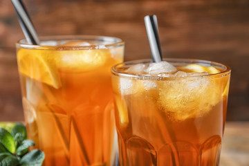 Tasty refreshing lemonade with ice in glasses, closeup