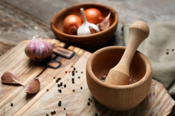 Wooden kitchen utensils with ingredients on table