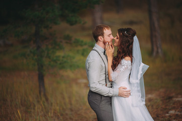 stylish bride and groom walking in nature