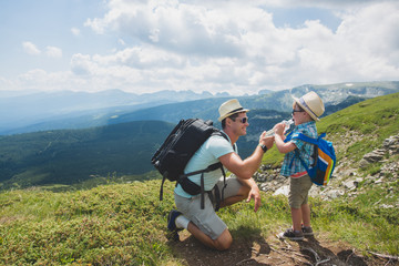 Father and son traveling in Rila mountains Bulgaria