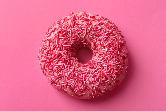 Delicious donut on color background