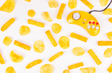 Yellow joystick and potato chips. Harmful food and gamepad. GamePad. © alatielin