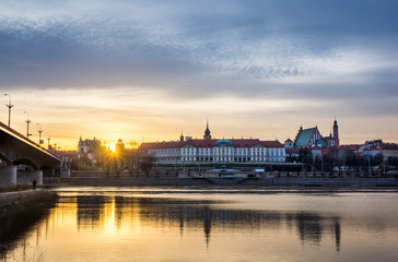 Fototapeta na wymiar Sunset over the Royal castle and old town on the other side of Vistula river in Warsaw, Poland