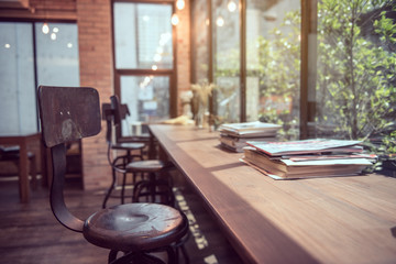Books on wooden table in vintage cafe.Interior