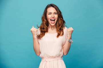 Excited young lady standing isolated