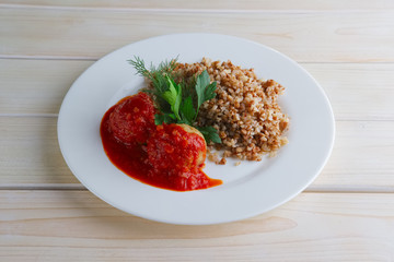 Traditional russian meatballs with buckwheat and tomato sauce