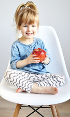 Portrait of Little Girl Eating Breakfast at Home Fruits Apple Summer Concept of Healthy Food for Children