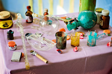Different dirty beakers and tubes on table. Horizontal color photography.