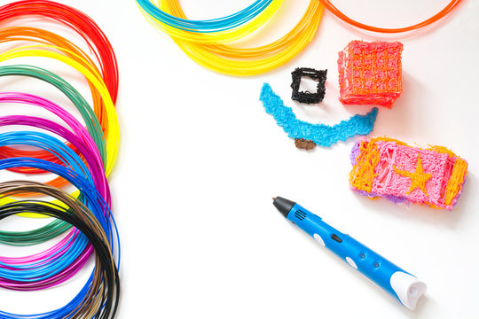 Colorful rainbow plastic filaments with for 3D pen laying on white. New toy for child. 3d paintings and figures with their own hands.