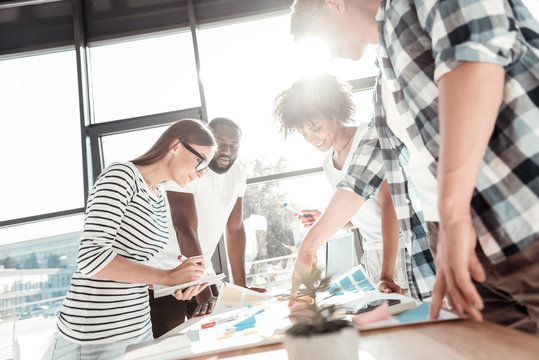 Professional Team. Happy Creative Young People Standing Around The Table And Working In Team While Being At The Office