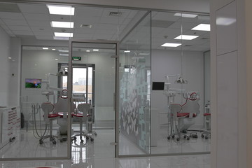 Modern dental practice. Dental chair and other accessories used by dentists in blue, medic light