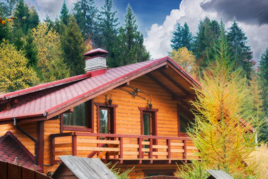 Wooden House Among Autumn Wood