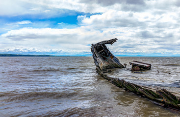 Baie-Saint-Paul in Quebec, Canada shipwreck in water with waves