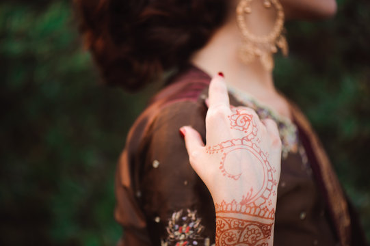 Mehndi covers hands of Indian woman