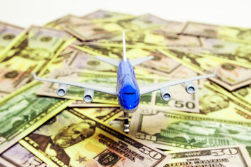 Blue white airplane on dollar and euro in cash close-up. Financial concept. tourist concept.