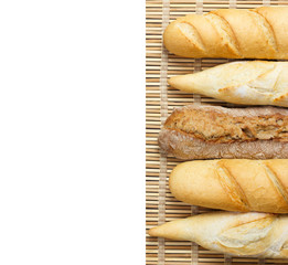baguette of whole wheat bread on a white background