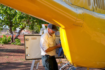 Fototapeta na wymiar Engineer maintaining a helicopter
