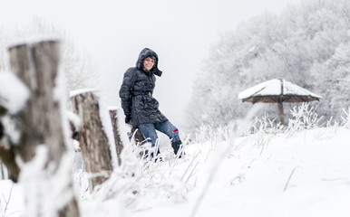 Fototapeta na wymiar Portrait of happy, middle age woman on winter landscape