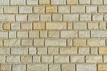 Yellow sandstone bricks wall background abstract texture.