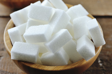 Sugar cubes in a wooden bowl