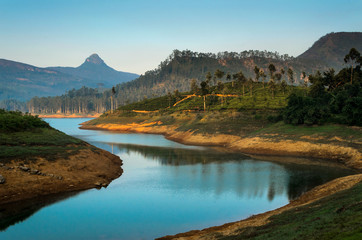 The sacred Sri Pada mountain also known as Adam's peak in Sri Lanka, seen from maskeliya reservoir