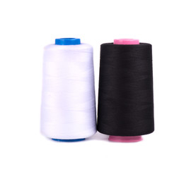 Sewing threads isolated on white background. White and black thread for tailoring sewing.