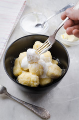 Lazy vareniki with cottage cheese (nioki) with sugar, butter and sour cream. Traditional European cuisine.