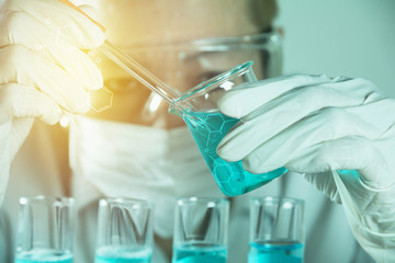 Researcher with glass laboratory chemical test tubes with liquid for analytical , medical, pharmaceutical and scientific research concept.