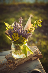 Bouquet of wild flowers in a pot on the table