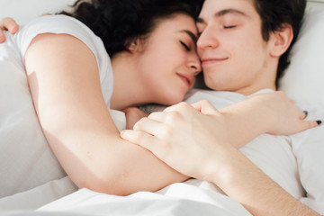 Obraz na płótnie Canvas Couple in love sleeps cuddling in bed