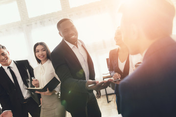 A group of young people holds brainstorming in the office.