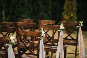 Very beautiful outside ceremony. classical wedding in forest. The arch is wooden. White flowers....