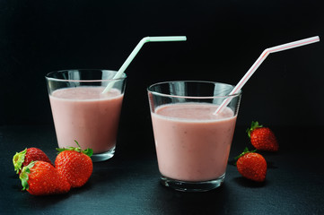 Strawberry milkshake glasses on dark background