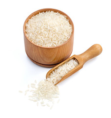 Wooden bowl and scoop with parboiled rice isolated on white background. Healthy food. Copy space. High resolution product