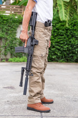 Fototapeta premium man in cargo pants with gun