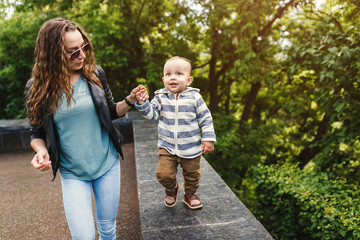 Happy Young woman with her son Walking In The Park.