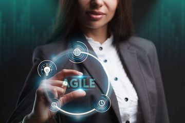 The concept of business, technology, the Internet and the network. A young entrepreneur working on a virtual screen of the future and sees the inscription: Agile